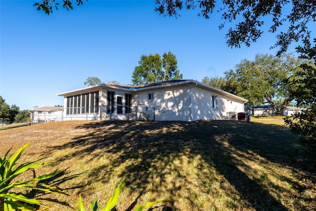10470 Southwest 61st Terrace Road Ocala, FL 34476 - Photo 57 of 63 a front view of a house with garden