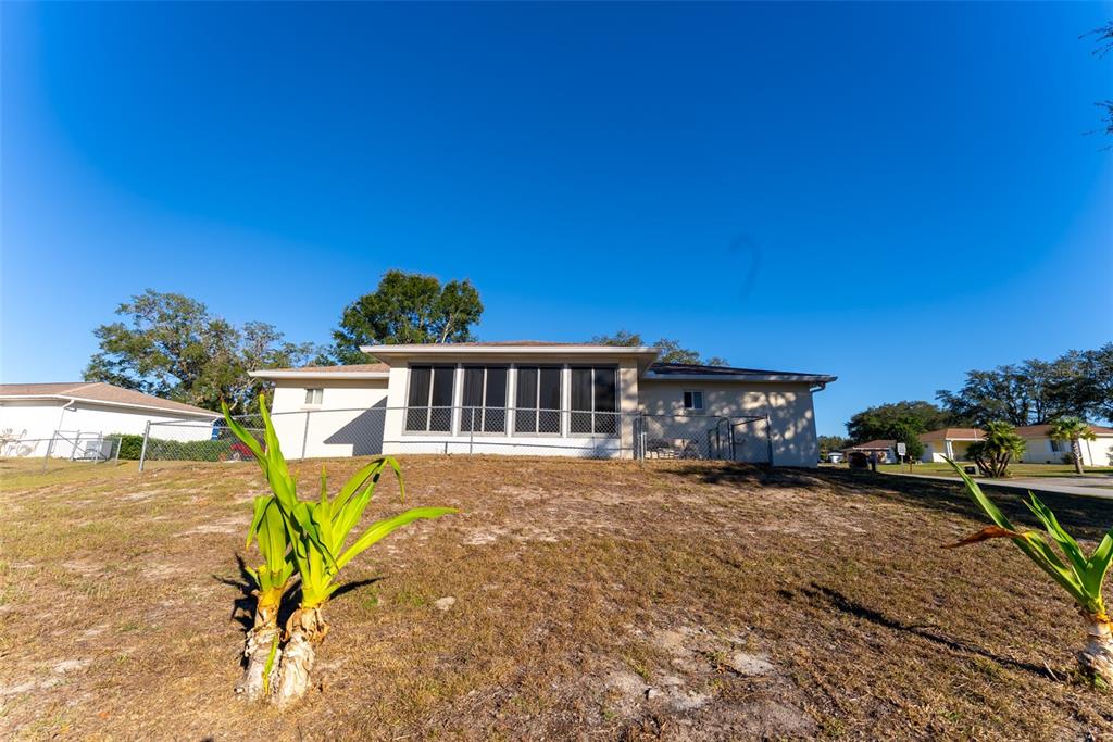 10470 Southwest 61st Terrace Road Ocala, FL 34476 - Photo 58 of 63 a view of a house with a yard