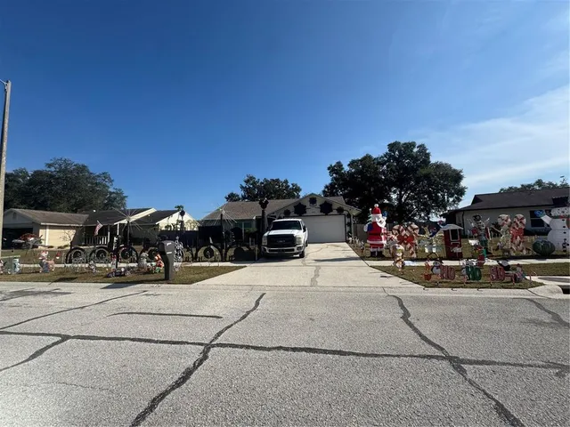 a front view of a building with lots of trees