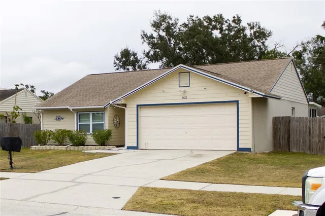 a kitchen with stainless steel appliances granite countertop a refrigerator a sink a stove and a dining table