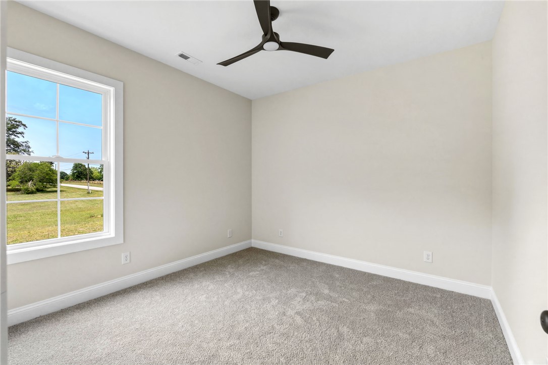 1735 Maw Bridge Road Central, SC 29630 - Photo 24 of 38 This airy bedroom offers soft carpeting and ample natural light, ideal for peaceful living.