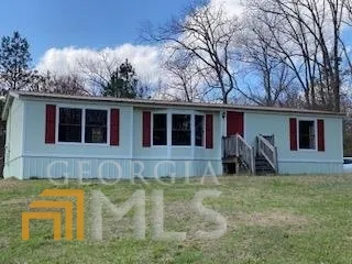 a house view with swimming pool in front of it