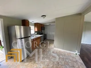 a kitchen with refrigerator and window