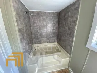 a bath tub sitting next to a sink