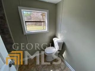 a bathroom with a toilet and a sink