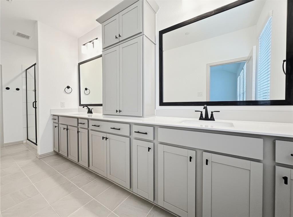 2837 Bluejack Road McKinney, TX 75071 - Photo 21 of 40 a spacious bathroom with double sink and a mirror