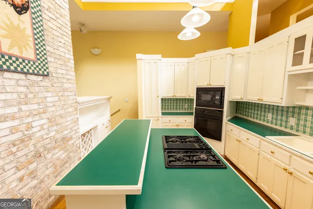 a living room with furniture a flat screen tv and a large window