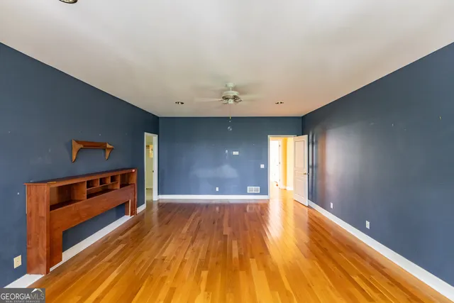 a view of an empty room and wooden floor