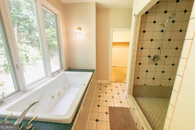 a spacious bedroom with a bed and wooden floor