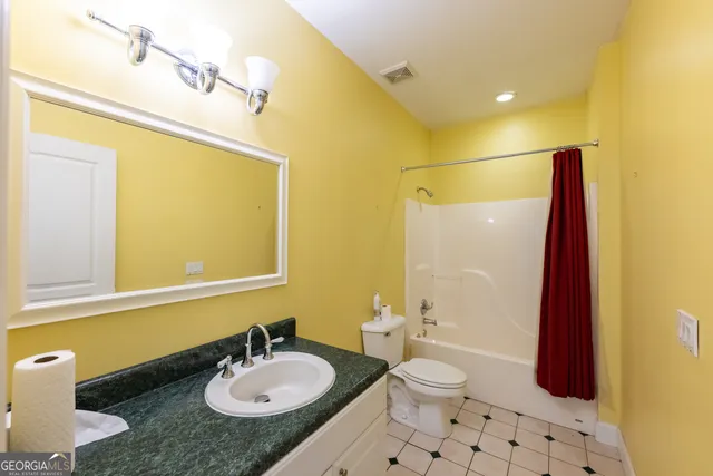 a view of a house with a yard and wooden fence