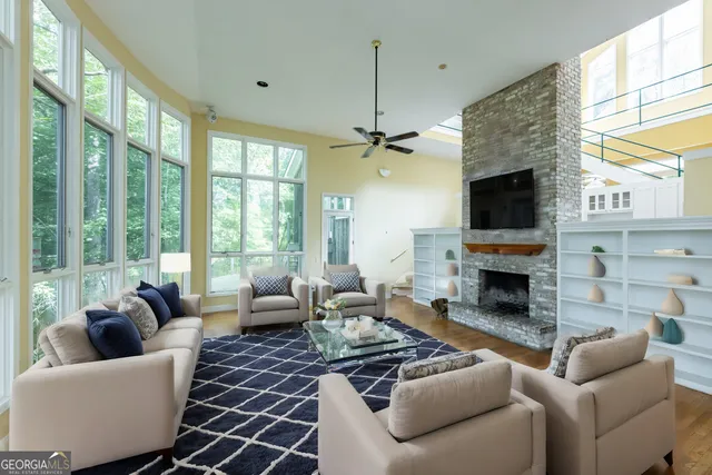 a view of an empty room with a fireplace and a window