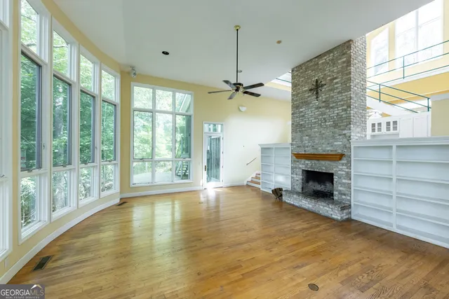 a living room with furniture fireplace and a large window