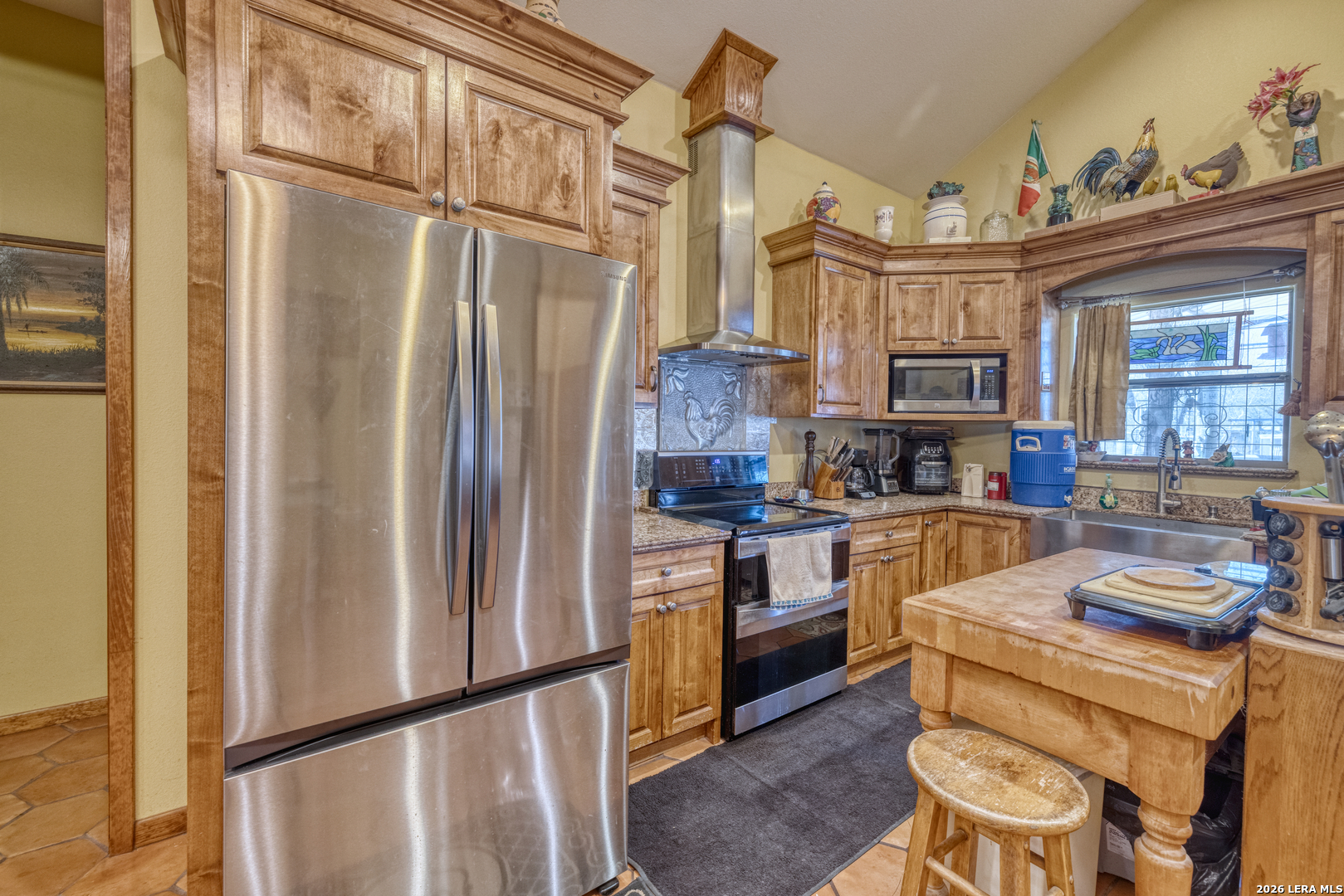 1140 Curtis Bourne Road Crystal City, TX 78839 - Photo 19 of 54 a kitchen with stainless steel appliances granite countertop a refrigerator a stove and a sink with wooden floor