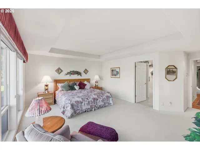 a large bedroom with a large bed and a large window