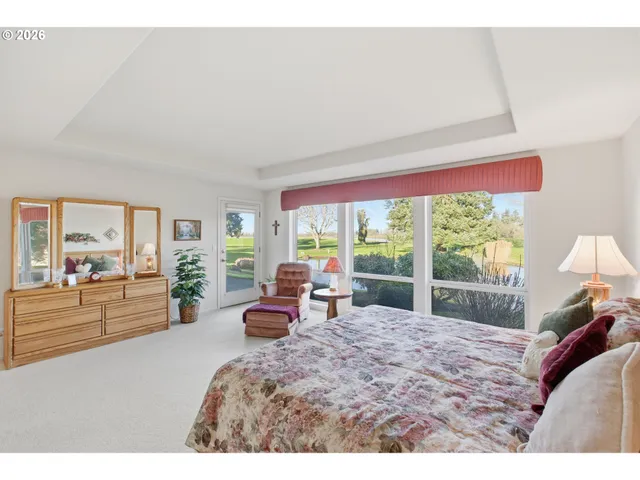a bathroom with a granite countertop double vanity sink mirror bathtub and shower