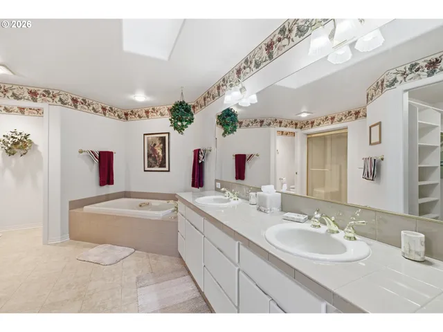 a bathroom with a bathtub a mirror and a sink