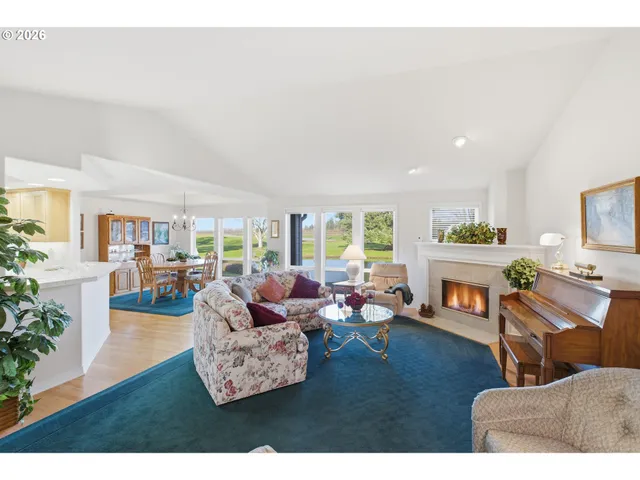 a living room with fireplace furniture and a wooden floor
