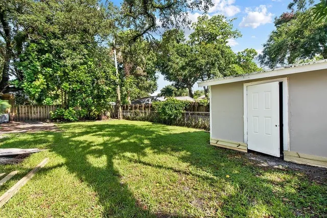 a view of a backyard with large trees