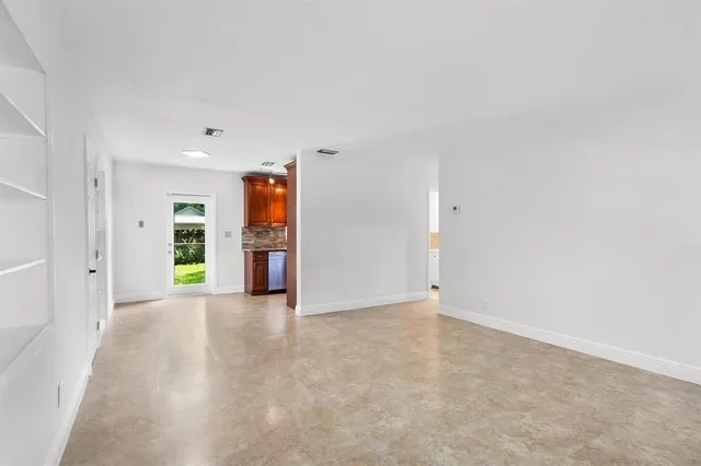 an empty room with closet and windows