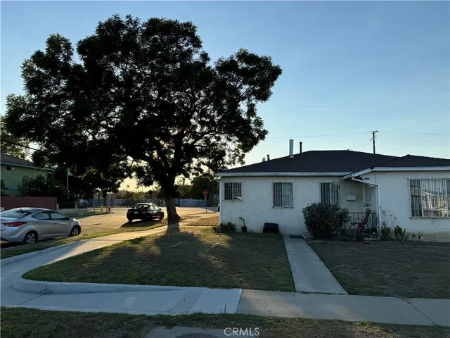 a view of a white house with a yard