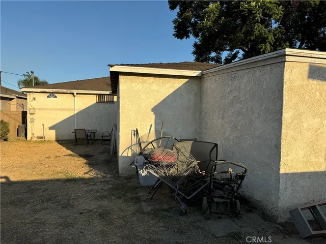 a backyard of a house with table and chairs
