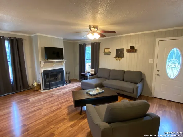 a living room with furniture a flat screen tv and a fireplace