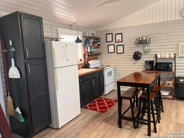 a kitchen with stainless steel appliances granite countertop a refrigerator and a stove