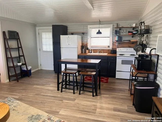 a dining room with furniture and wooden floor