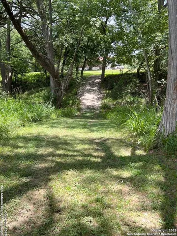 a backyard of a house with a yard and outdoor seating