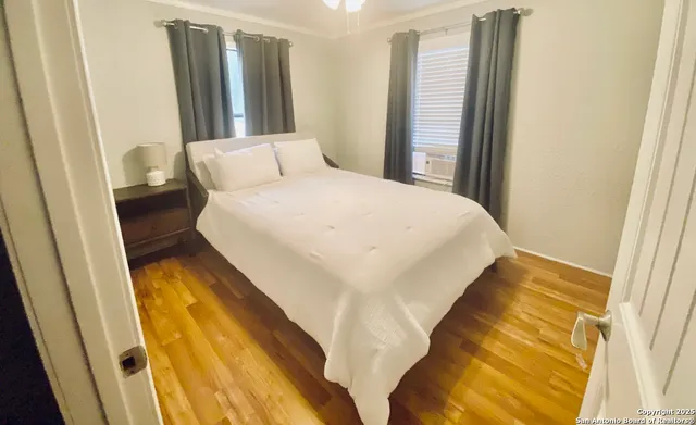 a bedroom with a bed and a window