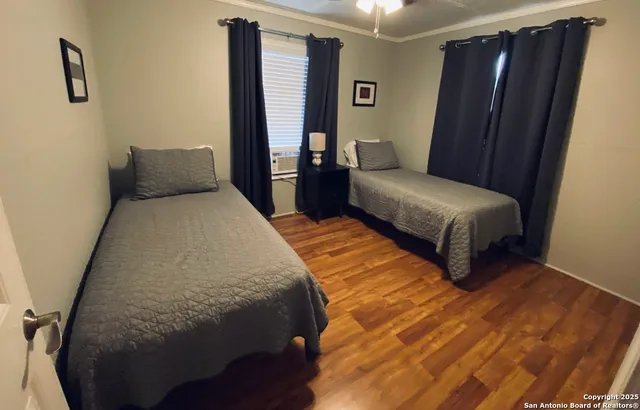 a bedroom with a bed and wooden floor
