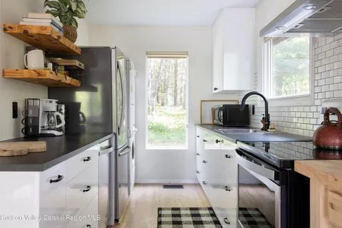 a view of a dining room with furniture window and flowerpot
