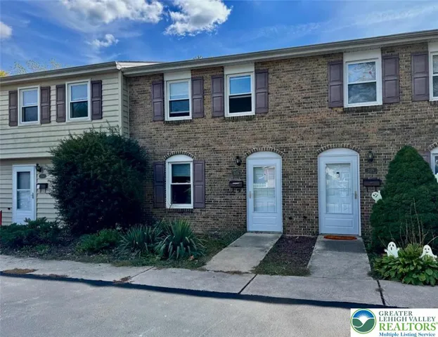 a front view of a house with yard