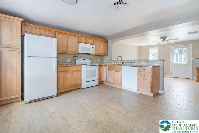 a kitchen with stainless steel appliances granite countertop a stove and a refrigerator