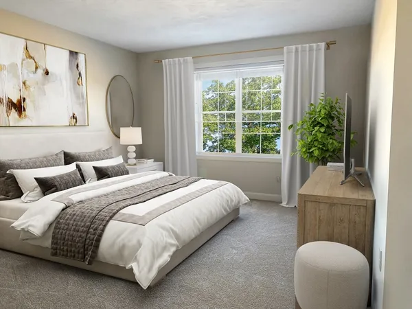 a bedroom with bed and a potted plant