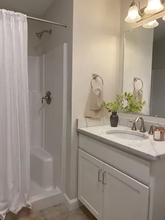 a bathroom with a granite countertop sink and a mirror