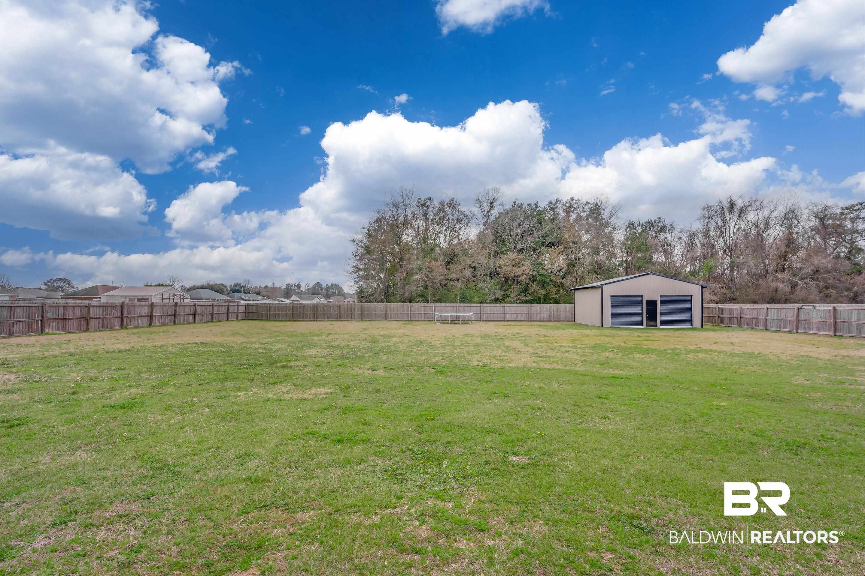13235 Tom Gaston Road Mobile, AL 36695 - Photo 24 of 43 View of yard with a garage and an outdoor structure