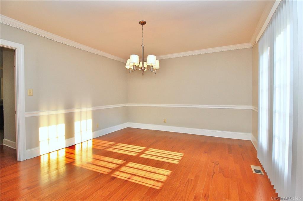 4312 Carmel Road Charlotte, NC 28226 - Photo 12 of 36 a view of a room with wooden floor and chandelier