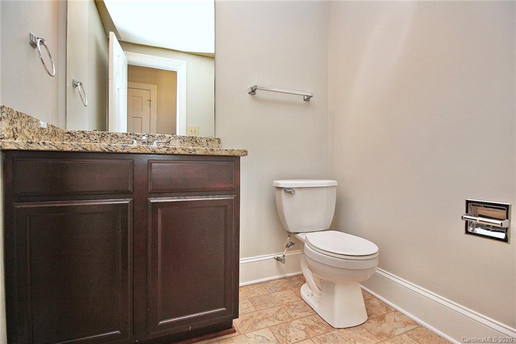 4312 Carmel Road Charlotte, NC 28226 - Photo 15 of 36 a bathroom with a granite countertop toilet and a sink