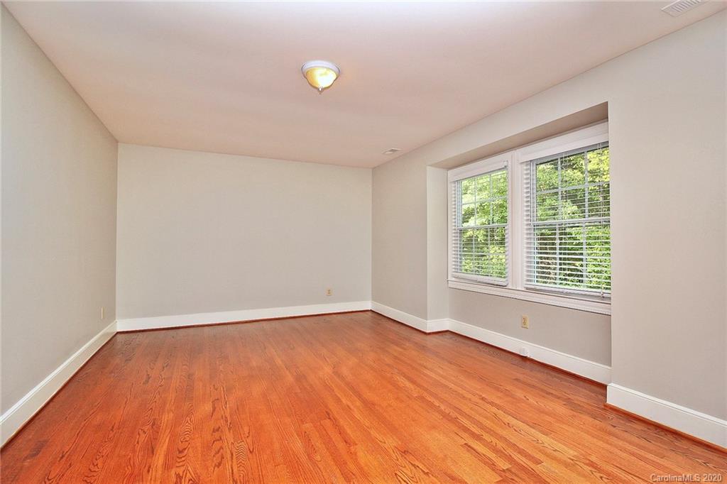 4312 Carmel Road Charlotte, NC 28226 - Photo 20 of 36 wooden floor in an empty room with a window