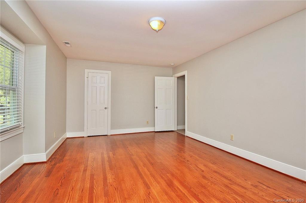 4312 Carmel Road Charlotte, NC 28226 - Photo 21 of 36 a view of an empty room with wooden floor and a window