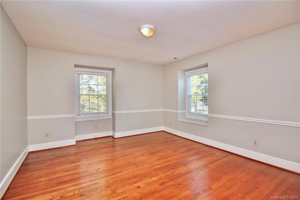 4312 Carmel Road Charlotte, NC 28226 - Photo 23 of 36 an empty room with wooden floor and windows