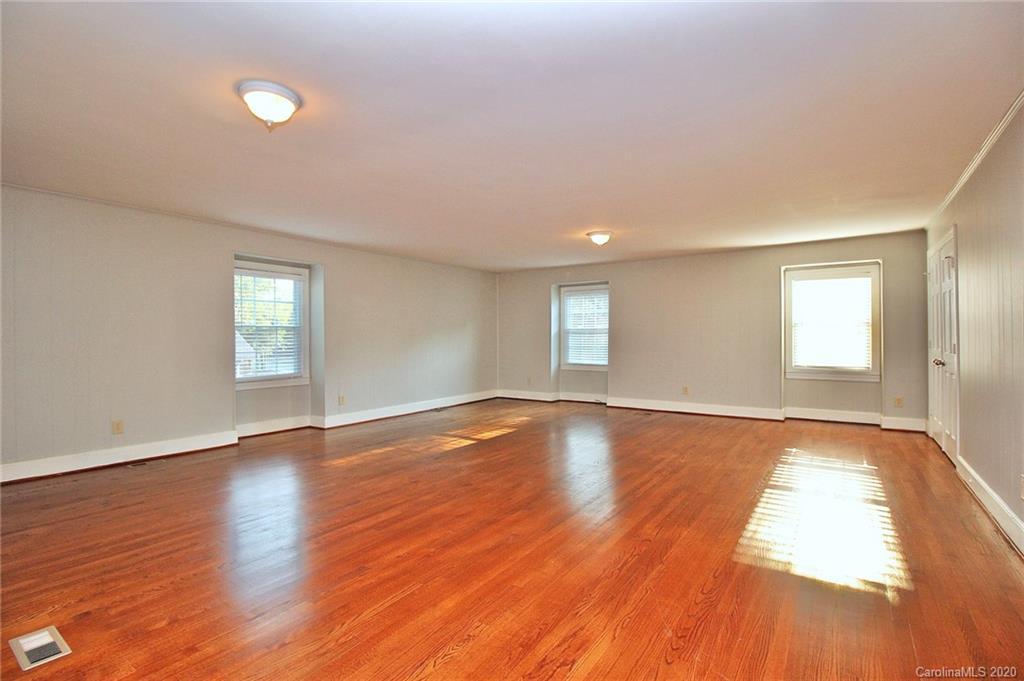 4312 Carmel Road Charlotte, NC 28226 - Photo 26 of 36 a view of an empty room with window and wooden floor