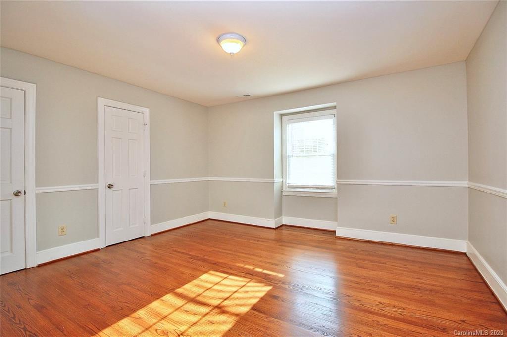 4312 Carmel Road Charlotte, NC 28226 - Photo 27 of 36 an empty room with wooden floor and window