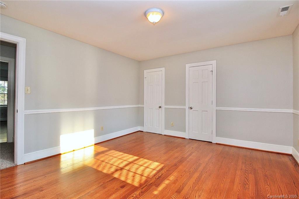 4312 Carmel Road Charlotte, NC 28226 - Photo 28 of 36 an empty room with wooden floor and closet