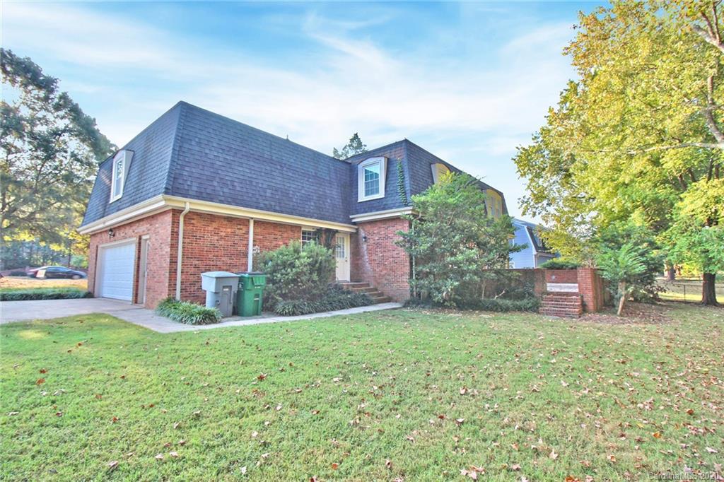 4312 Carmel Road Charlotte, NC 28226 - Photo 30 of 36 a view of a yard in front of a brick house with large windows