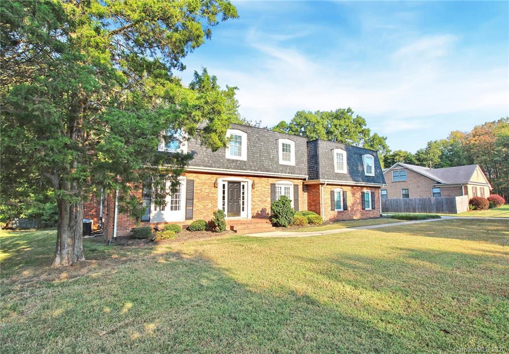 4312 Carmel Road Charlotte, NC 28226 - Photo 36 of 36 a front view of residential houses with yard and trees