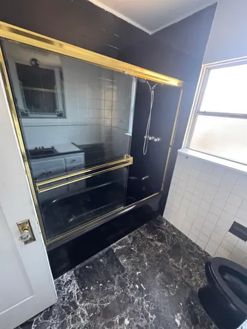 a front view of a house with plants and outdoor seating