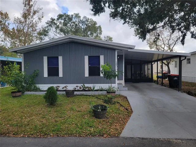 a view of a house with pool yard and chairs