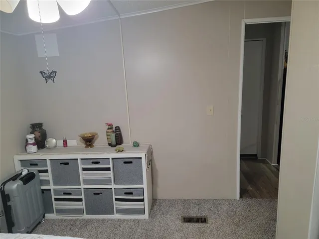 a white toilet sitting next to a white sink and a shower curtain